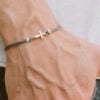 thin rope bracelet with cross charm