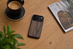 buko walnut wood case on a light brown wooden desk with a coffee, plant and magazine.