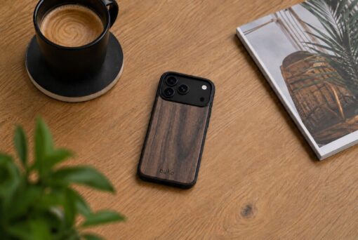 buko walnut wood case on a light brown wooden desk with a coffee, plant and magazine.