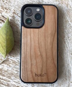 Buko natural wood iPhone case with slim black bumper on rustic timber surface with leaf