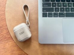 gold leather AirPods case with MacBook