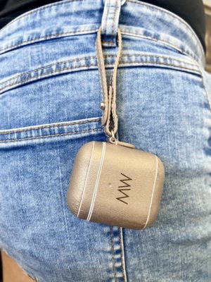 Gold leather AirPods case hooked on jeans