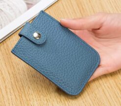 Women holding light blue card wallet