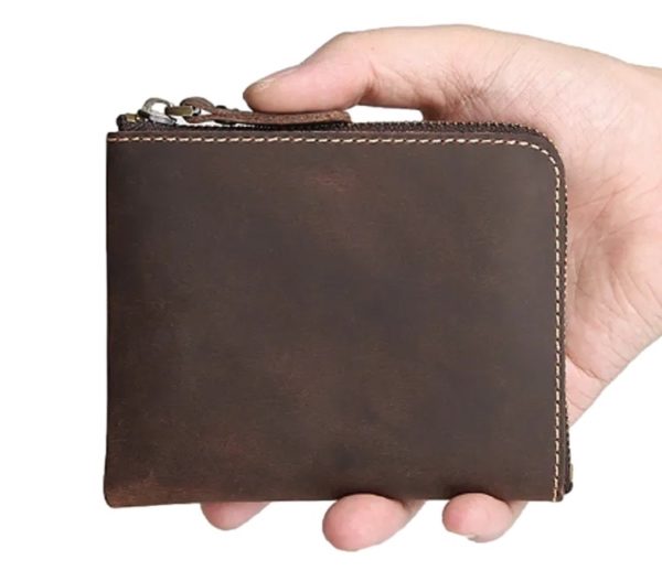 Holding a brown leather zip wallet