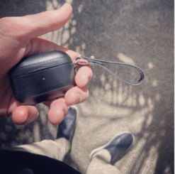 Man holding black leather AirPods Pro case