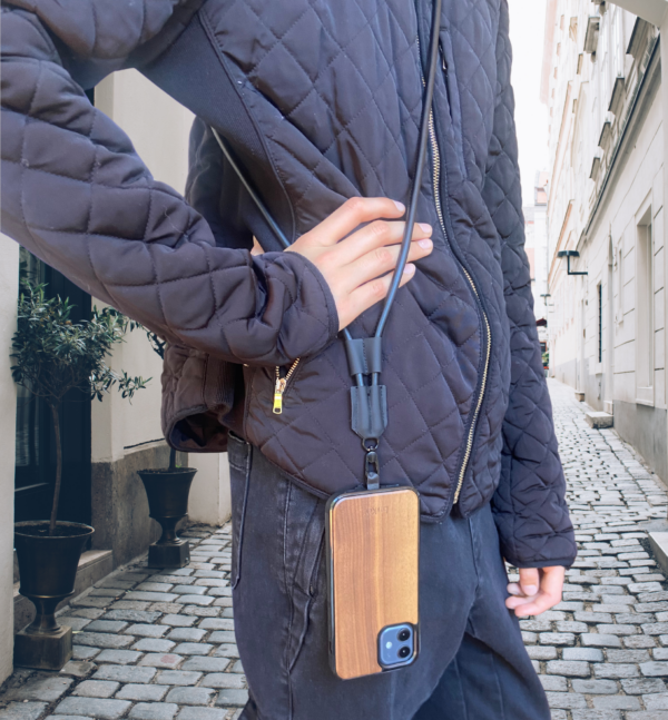 Woman wearing a leather crossbody phone strap lanyard