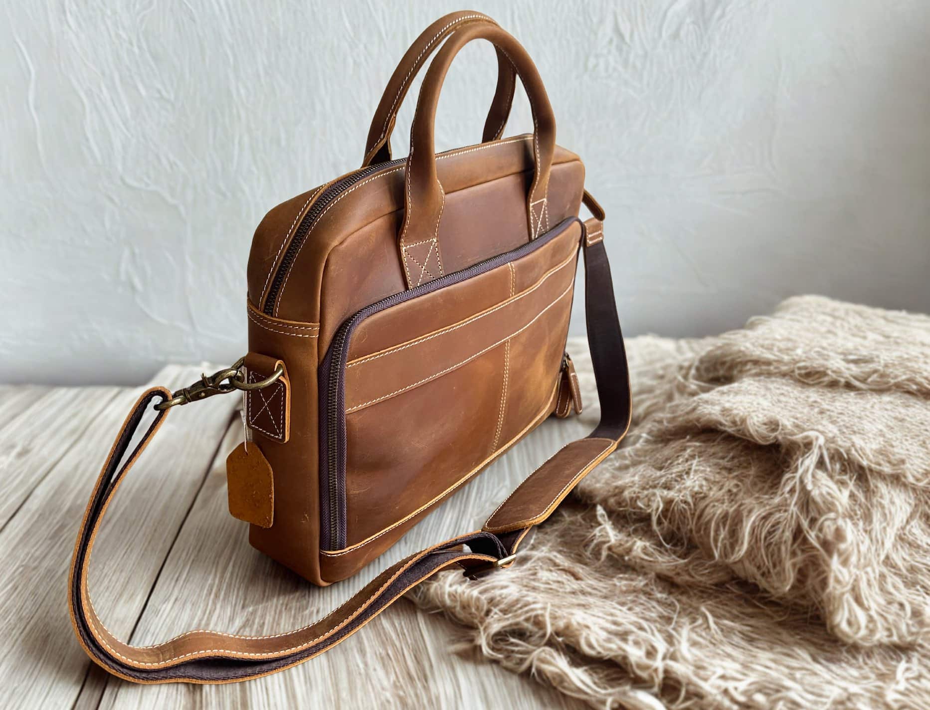 full grain leather laptop briefcase on a wooden table