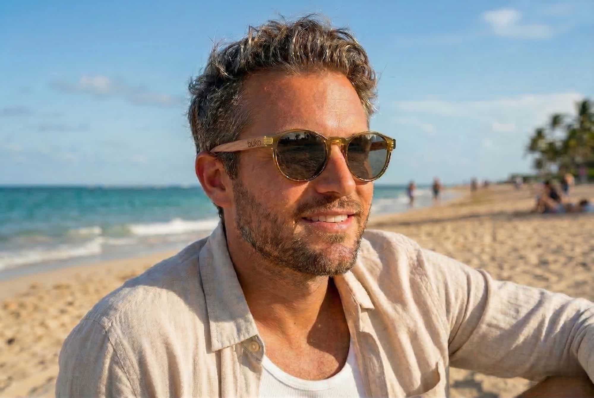man wearing Rosco olive sunglasses on the beach