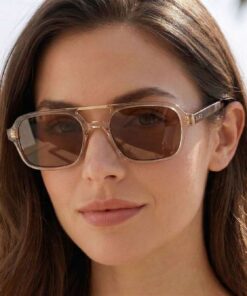 brando champagne sunglasses on a female model with palm trees in background