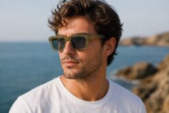 Man wearing Cove sunglasses Kelp colour with transparent green recycled PET frame and dark polarised lenses by buKo coastal lifestyle