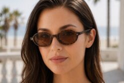 Female model wearing Tropez thin almond round tortoiseshell sunglasses with brown polarised lenses by Buko