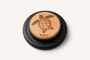 buKo MagSafe Phone Holder & Stand with engraved turtle design on natural wood and matte black base